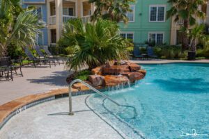 A swimming pool with a small waterfall